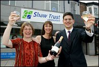 David Miliband MP celebrates with Jane Cox and her Shaw Trust Adviser Ann Tucker