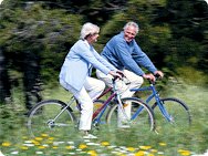 Photo of a middle aged man and woman riding bikes