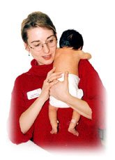 Midwife holding baby in arms