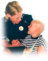 Nurse holding child's hand